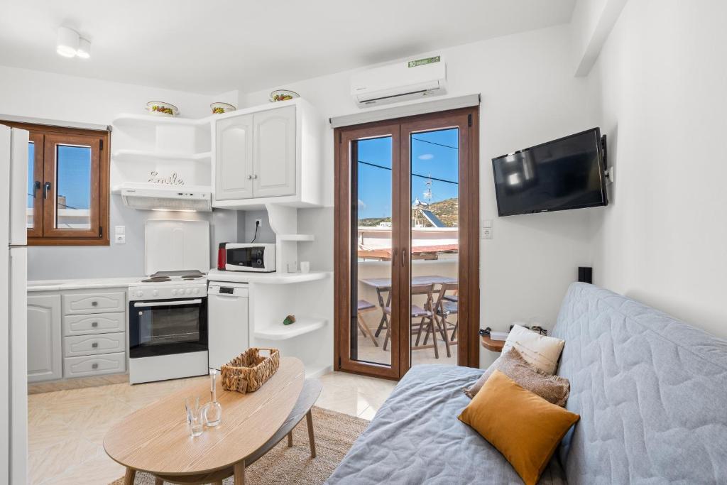 a living room with a couch and a table at Vivlos Stays - Ageri in Vívlos