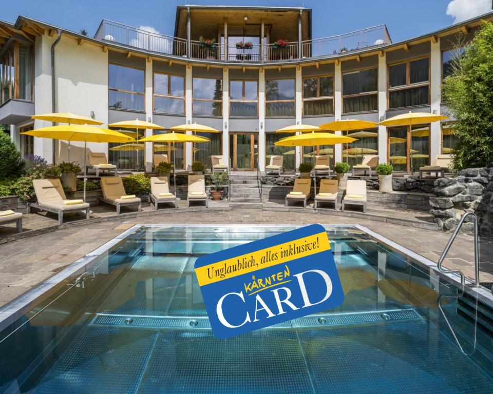 a hotel with a wanted card sign in front of a pool at Naturhotel Ortners Eschenhof in Bad Kleinkirchheim