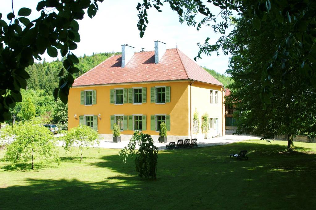 a large yellow house with a red roof at Domaine De Syam - Gîtes, Chambres d'hôtes & Cabanes in Syam