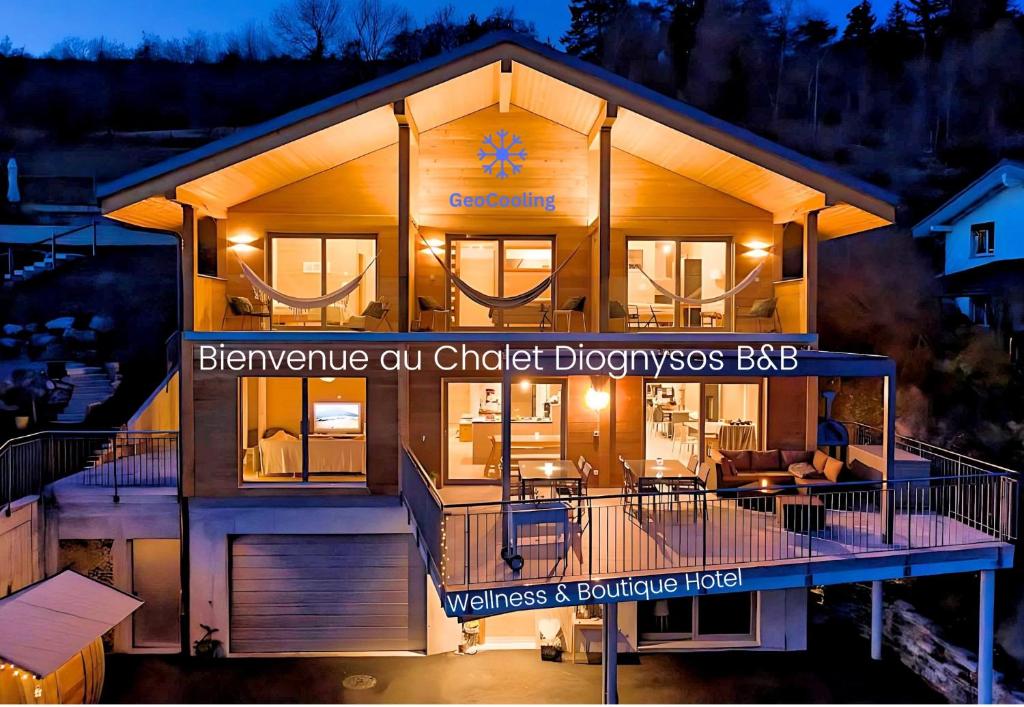 a home with a large deck with a house at Chalet Diognysos B&B, Wellness & Boutique Hotel, Valais Crans-Montana Diogne in Crans-Montana