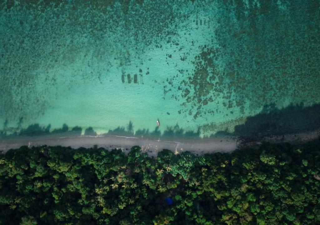 an aerial view of a beach in the rain at One Ocean Nature Conservation Centre in Kota Belud