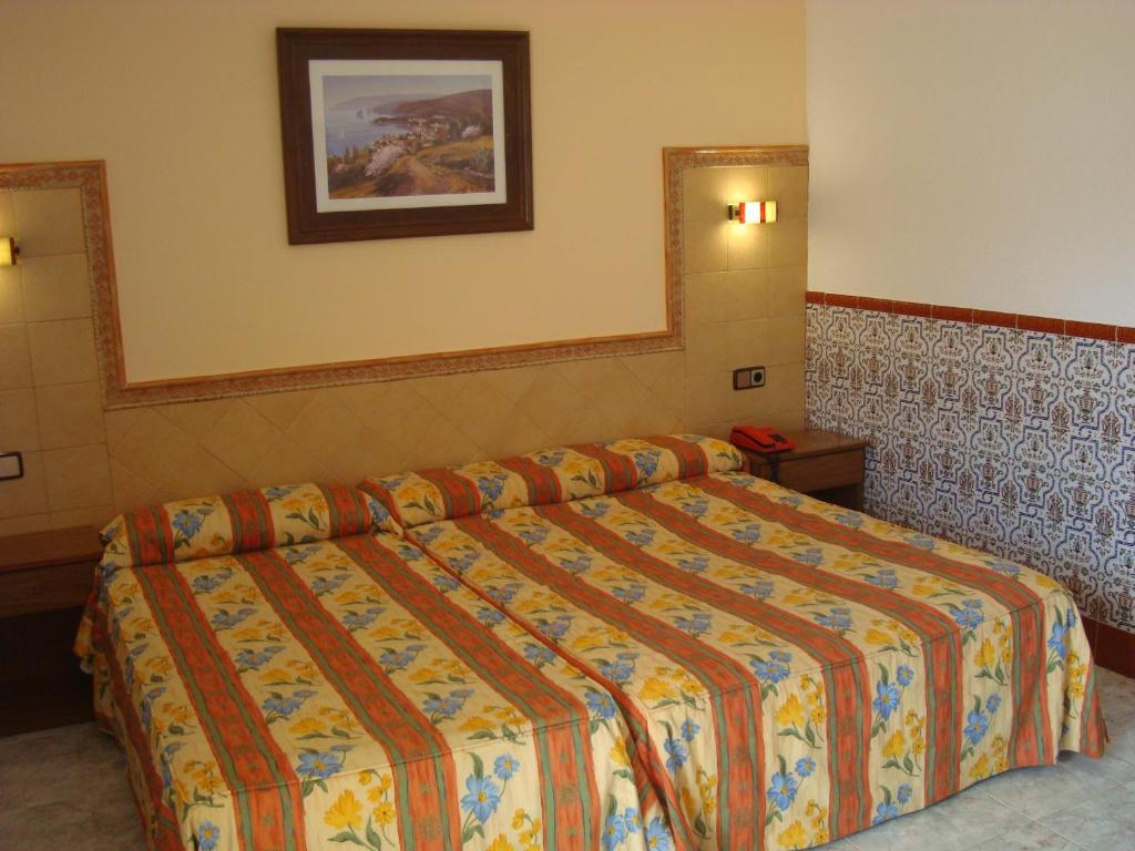 Postel nebo postele na pokoji v ubytování Hotel Univers