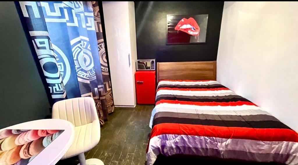 a small bedroom with a bed and a chair at Luxury KIA Room D in Richmond Hill