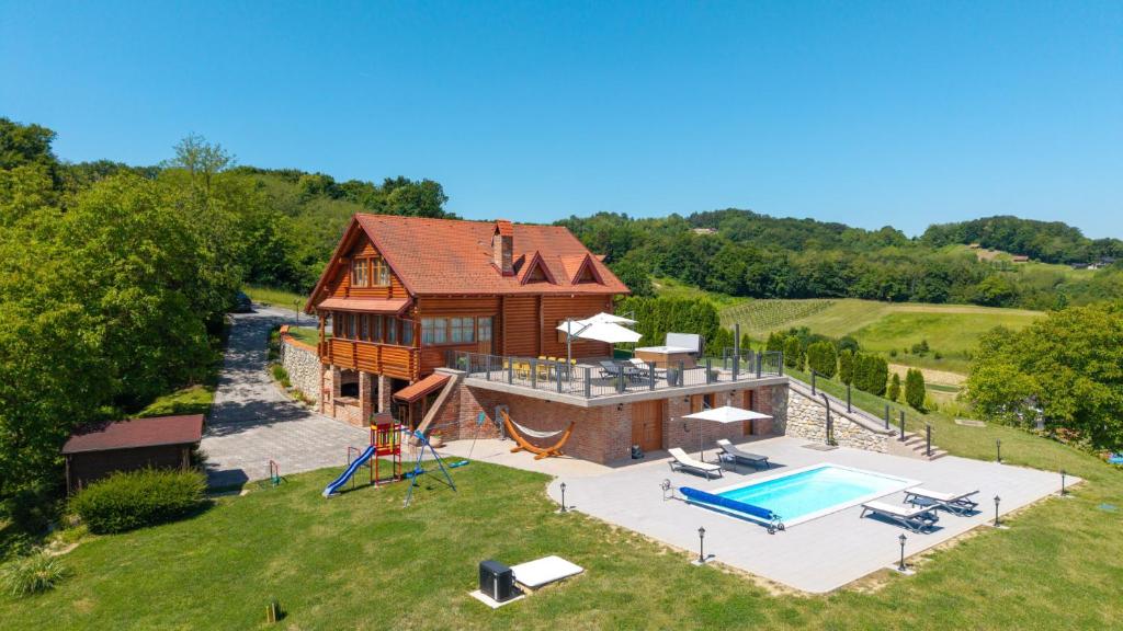 an aerial view of a house with a swimming pool at Villa Pine Log by Villas Guide in Dubrovčan