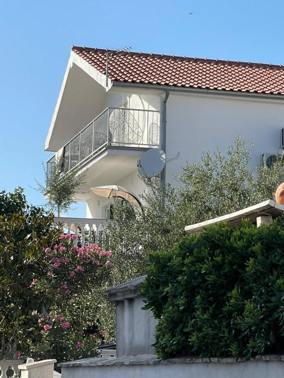 a building with a balcony on the side of it at Apartments Vodice in Vodice