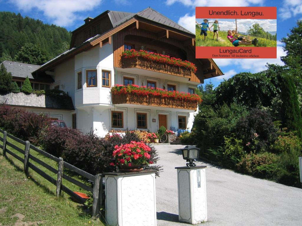 a house with flowers on the side of it at Gruber Alexandra, Appartement mit Lungaucard in Sankt Michael im Lungau