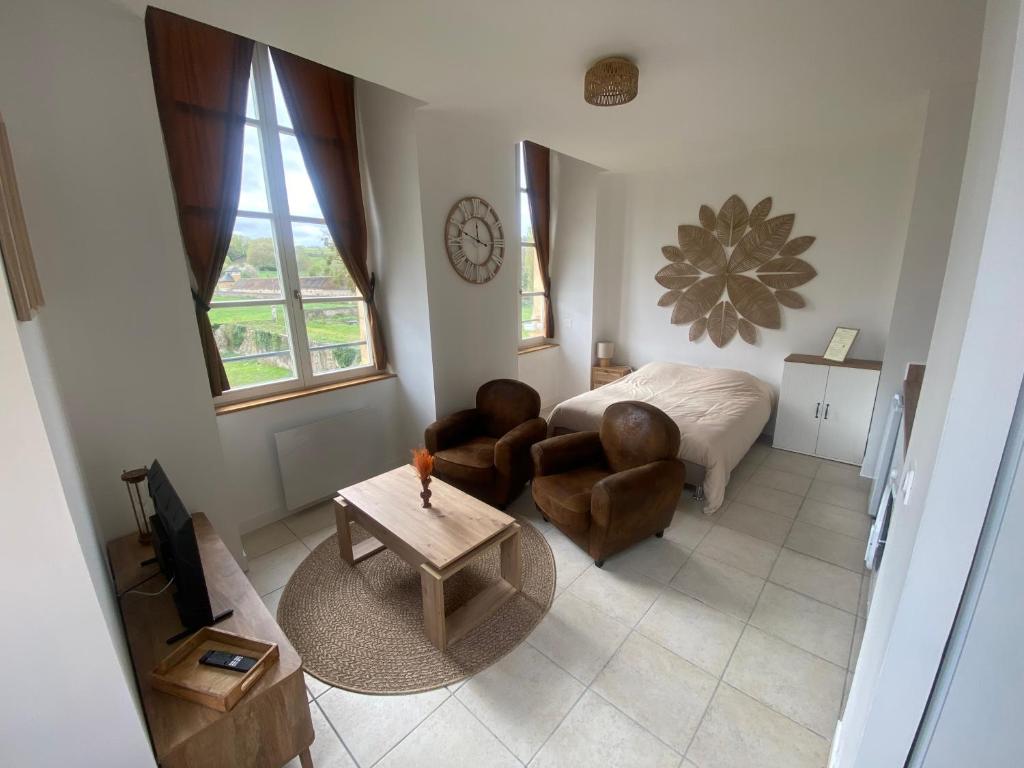 a living room with a bed and a table at Studio Château de Passy in Passy