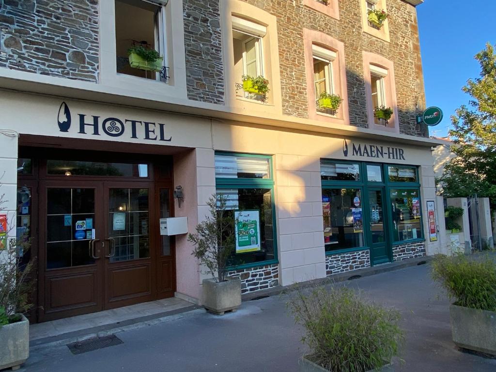 a hotel building with a door in front of it at Hôtel MAEN-HIR Dol Gare in Dol-de-Bretagne