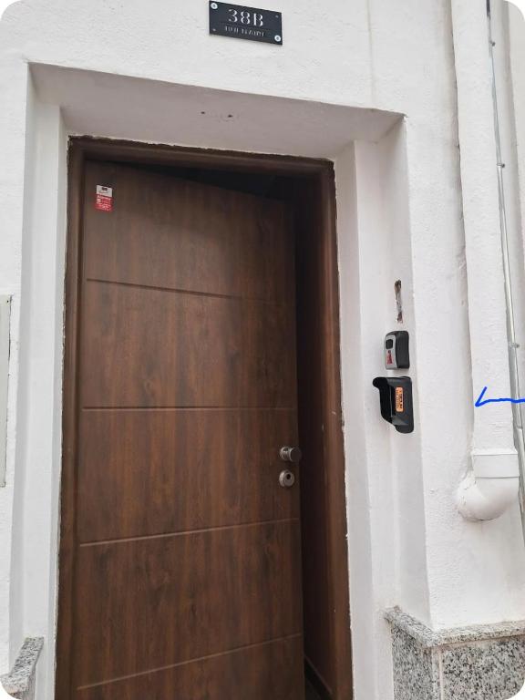 a brown door in a building with a sign on it at HcHOME in Algeciras