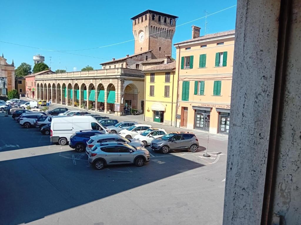 a parking lot with cars parked in front of a building at Guest House Soma Montecchio in Montecchio Emilia