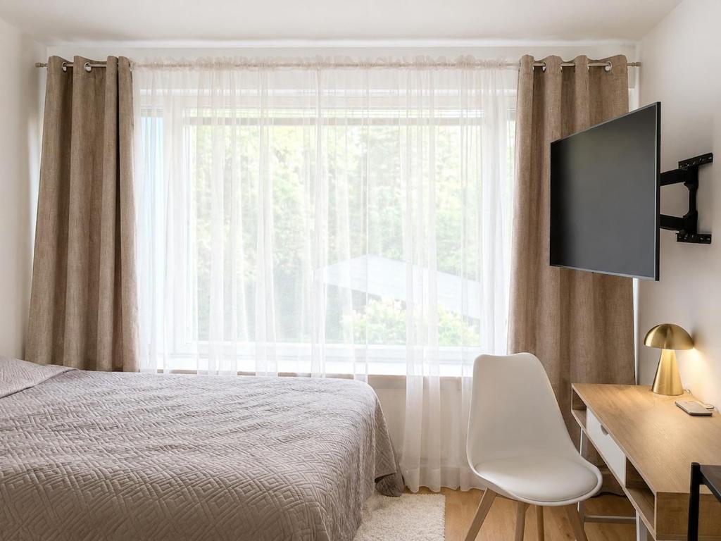 a bedroom with a bed and a desk and a window at Kotkan Studio in Kotka