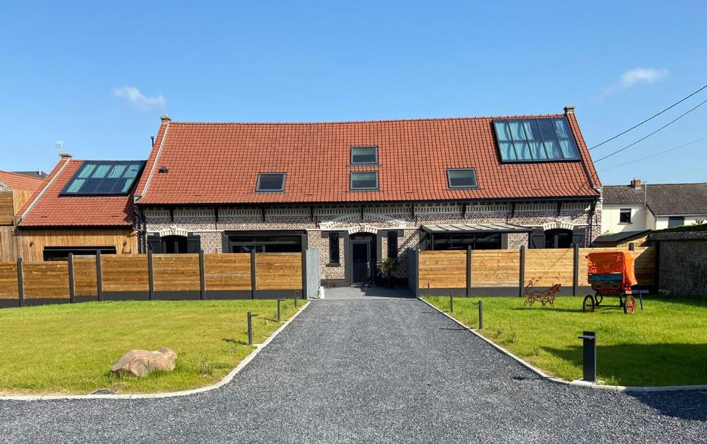 a house with a red roof and a driveway at L'Odyssée Inattendue in Étaing