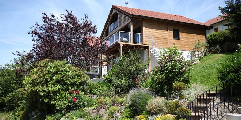 a house with a garden in front of it at chalets les biches in Gérardmer