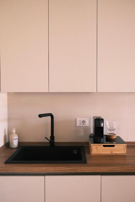 a kitchen counter with a sink and a coffee maker at Casa Delfina - Bergamo in Torre Boldone