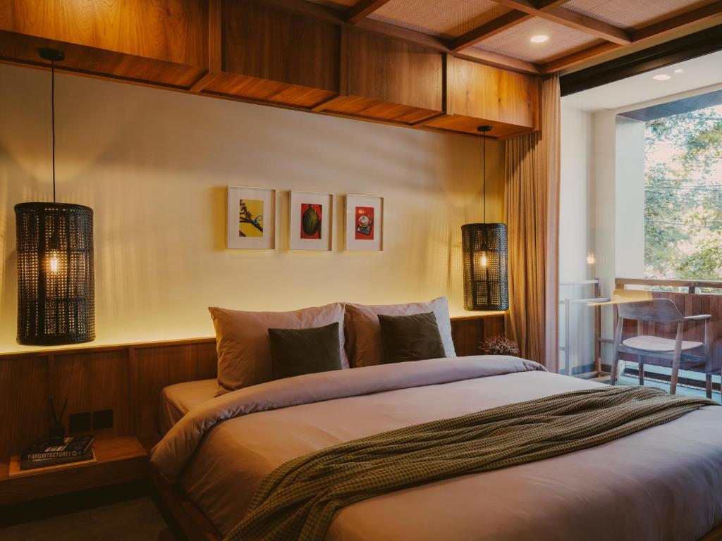 a bedroom with a large bed and a table at Anandaya Sanur in Sanur