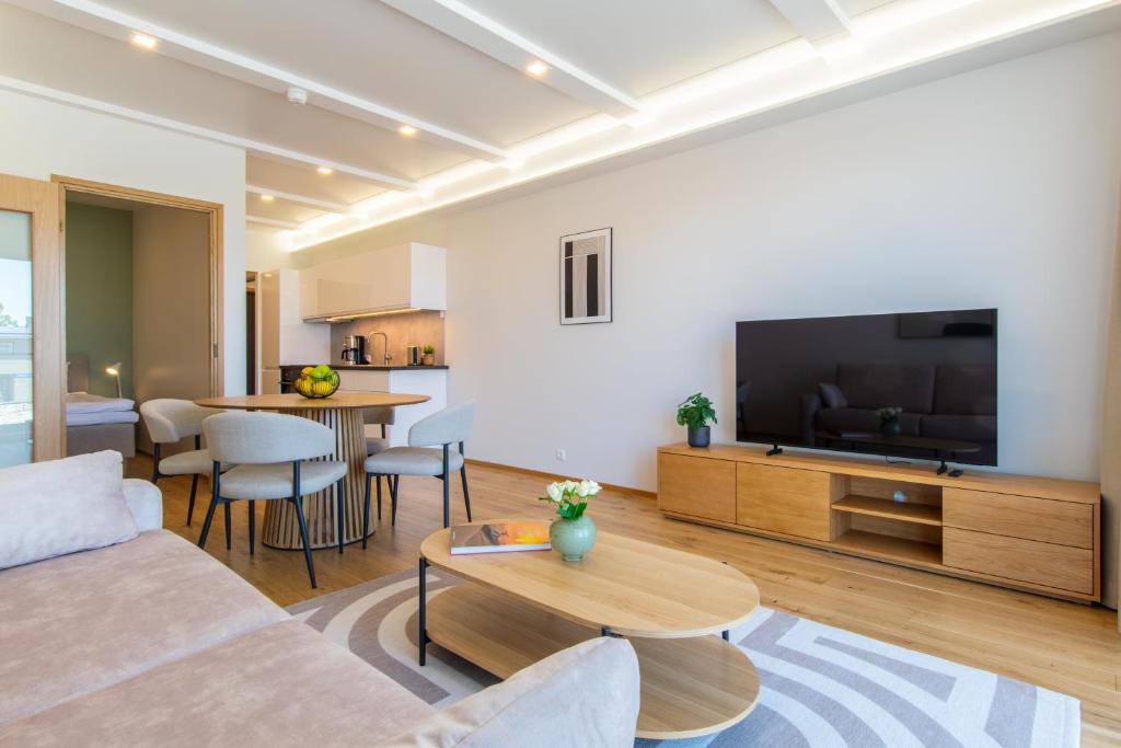 a living room with a couch and a flat screen tv at TEN Apartments - Kuressaare in Kuressaare