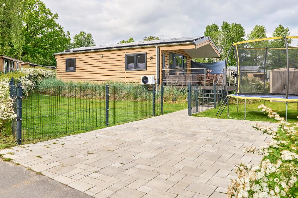 a backyard with a rv and a playground at Ferienhaus "Ostseeperle" mit kostenfreier Saunanutzung, Grundstück Umzäunt in Scharbeutz