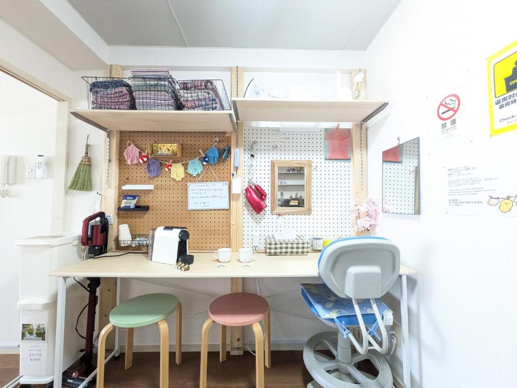 a room with a table and two stools at skyroom ijiri102 in Itazuke