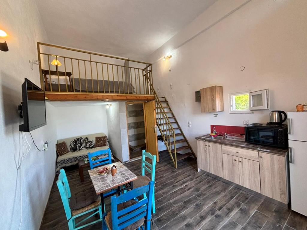 a kitchen with a dining table and a kitchen with a loft at Βαχος rooms 3 in Areopoli