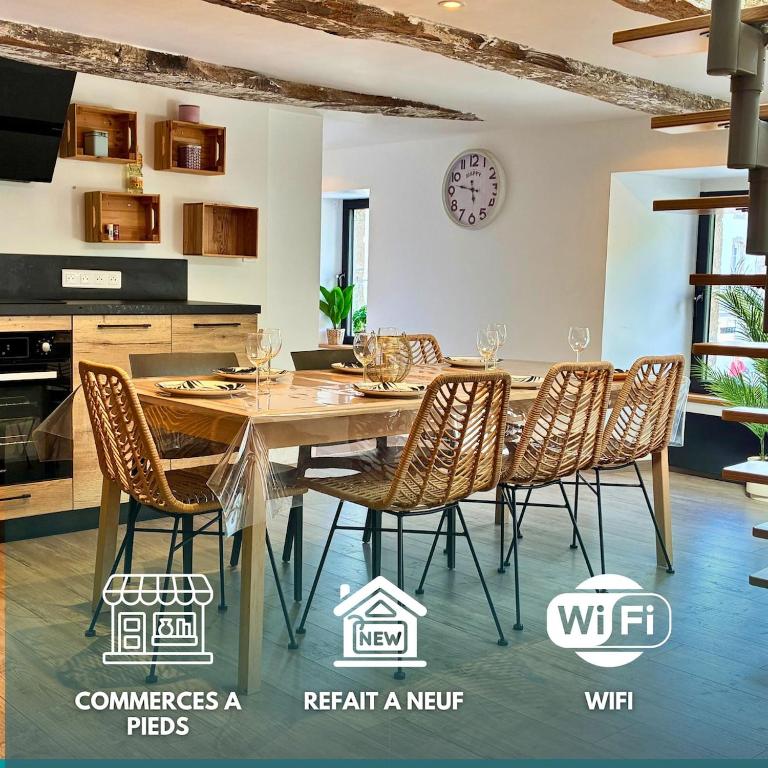 a dining room with a wooden table and chairs at Ty Neel - central - Wi-Fi in Crozon