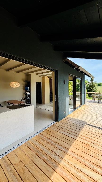 a house with a wooden deck with a view at Chosen Hideaway Near Cologne in Neunkirchen-Seelscheid