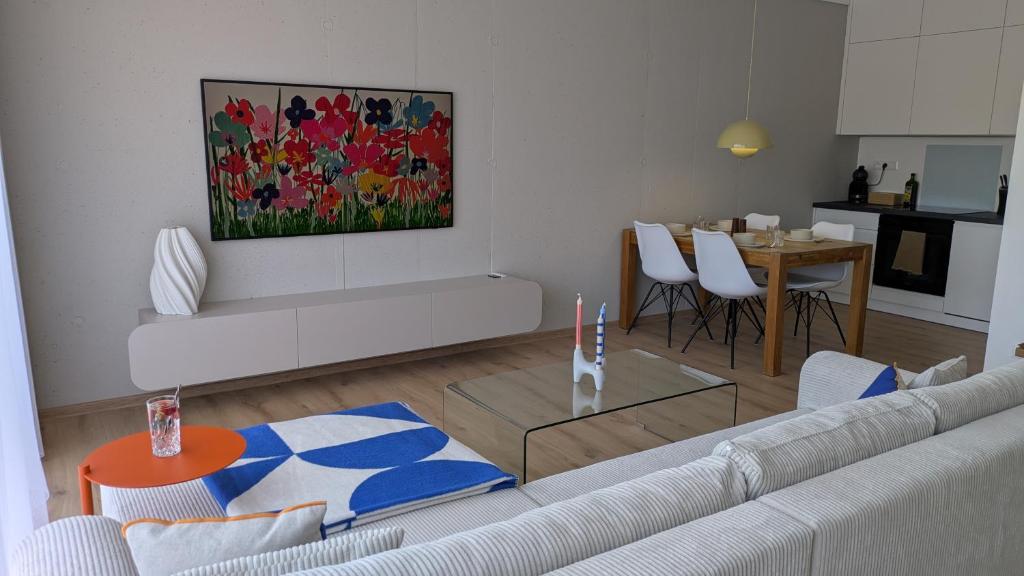 a living room with a white couch and a table at Apartment Nordic in Veselé