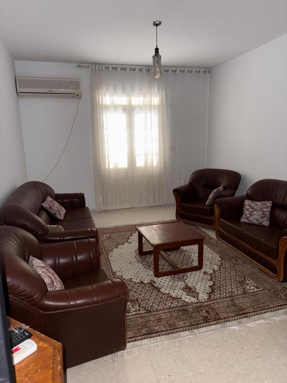 a living room with two couches and a coffee table at Beach apartment g in Sousse