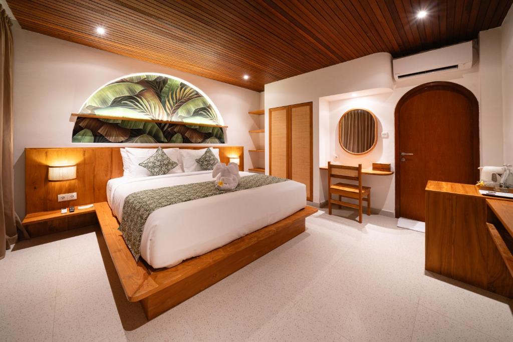 a bedroom with a large bed with a large window at Tepi Segara Seminyak in Seminyak