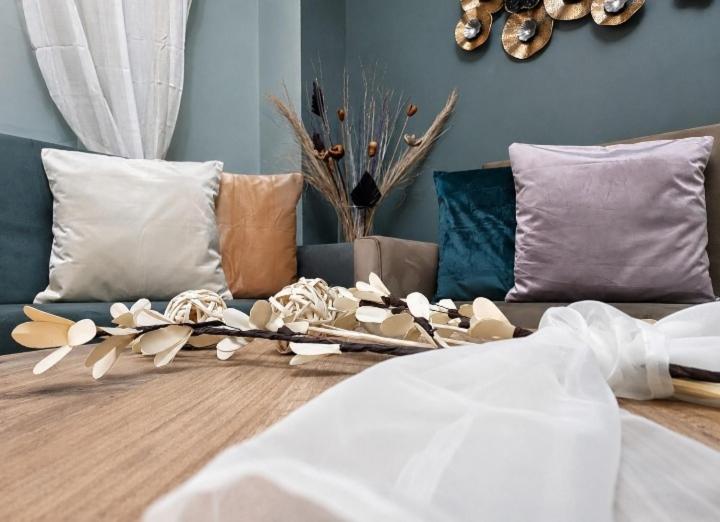 a living room with a couch with pillows at Duba Apartments 2 in Alexandroupoli