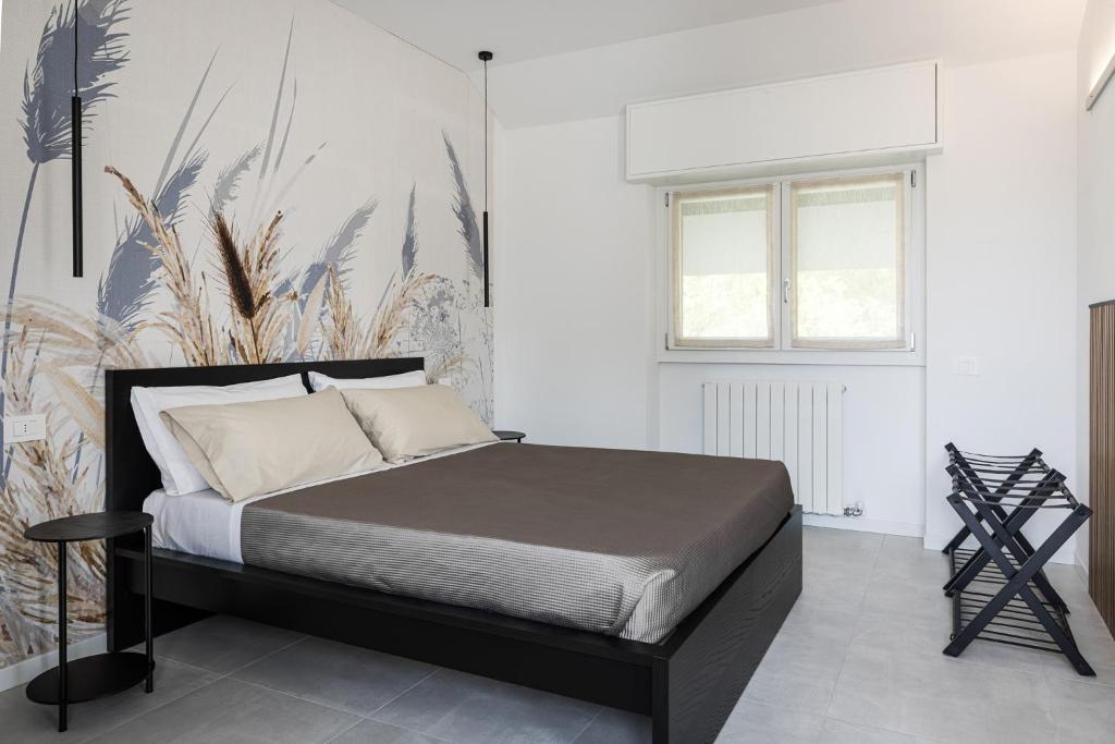 a bedroom with a bed and a wall with plants at Antares b&b in Cassina deʼ Pecchi