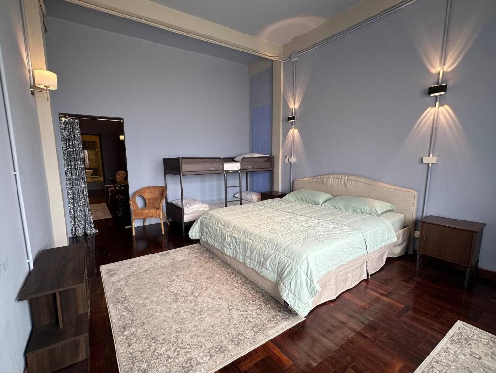 a bedroom with a bed and a room with a table at Room with a Temple View in Bangkok