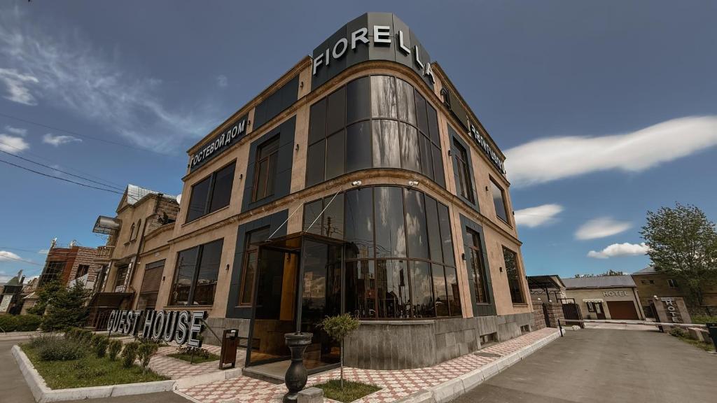 a building with a sign on the front of it at Fiorella Gyumri in Gyumri