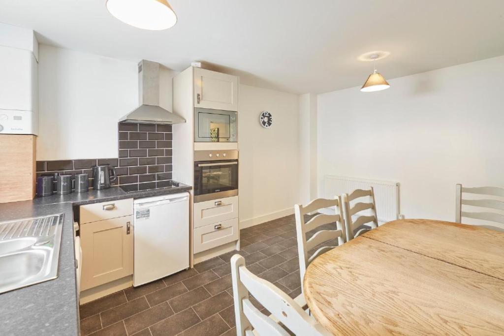 a kitchen and dining room with a table and chairs at Skinningrove Beach Apartment 5 in Skinningrove
