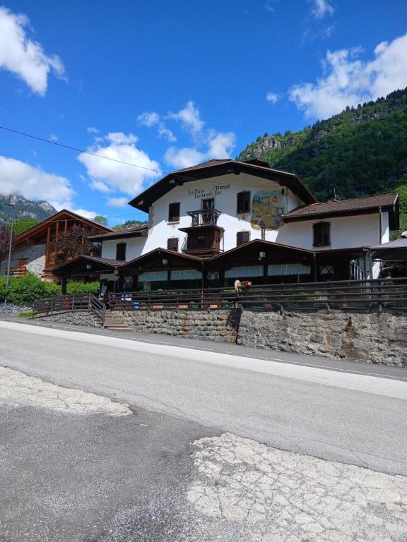 a large white building on the side of a road at LOCANDA Alla Paia in Pracul