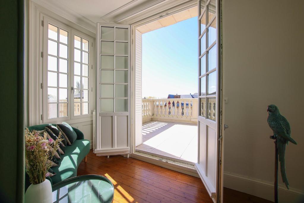 a parrot standing in a room with an open door at Quatorze - manoir au coeur du parc du Château de La Garnache in La Garnache