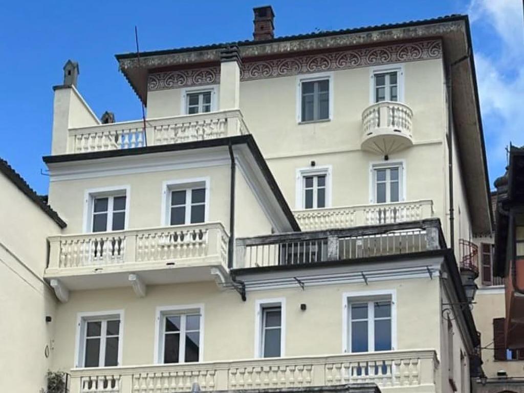 a white building with balconies on the side of it at Apartment Bacolla by Interhome in Cocconato