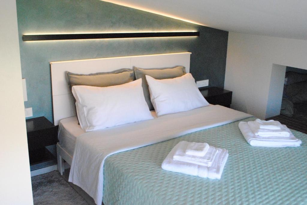 a bedroom with a bed with two towels on it at Sofita Rooms in Nafplio