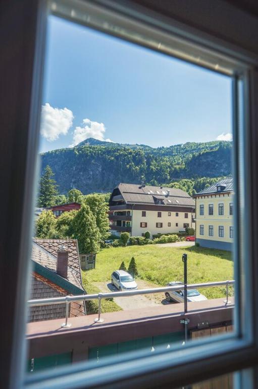 a window with a view of a street and buildings at Ferienwohnung 12er in Sankt Gilgen