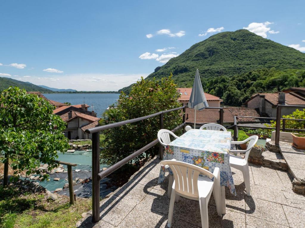 a table and chairs on a balcony with a view of the water at Apartment Piersa by Interhome in Mergozzo