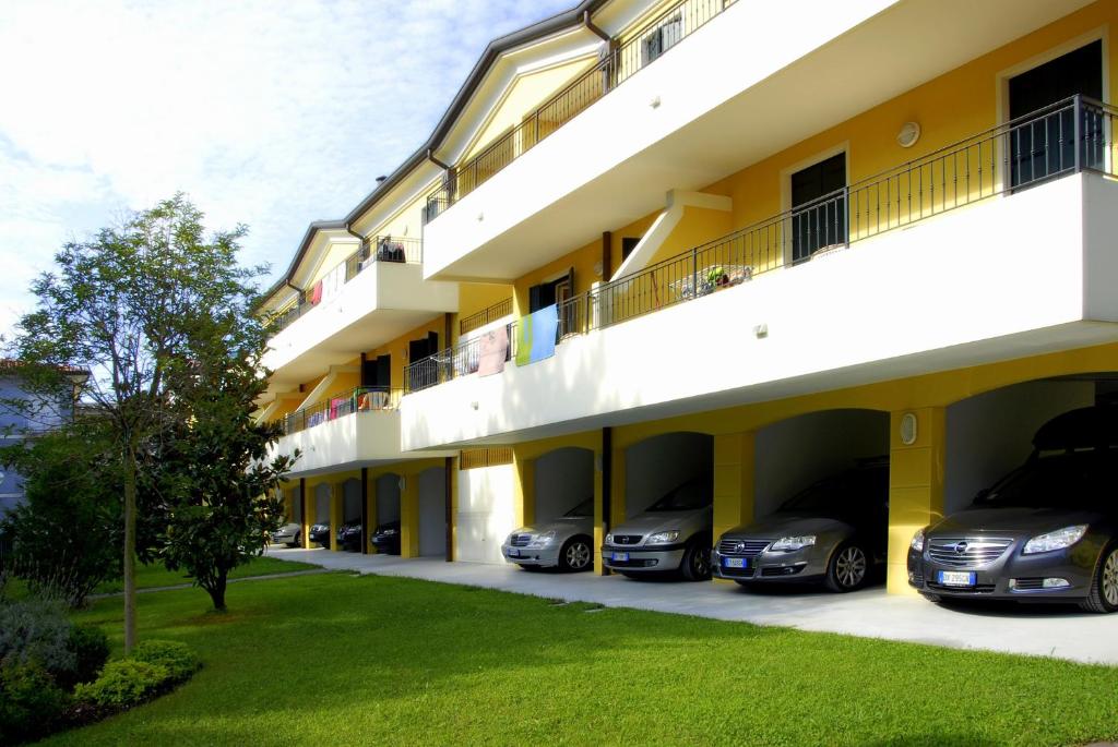 a row of cars parked in front of a building at Villa Poli in Bibione