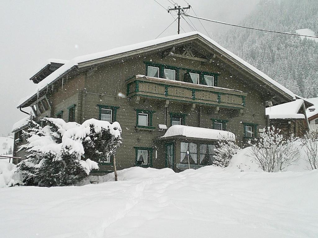 a large building covered in snow in front at Landhaus Hubert Fiegl in Sölden