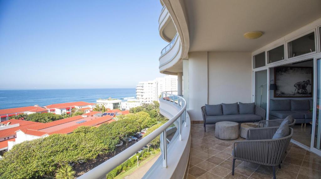 a balcony with a view of the ocean at 404 Oyster Rock - by Stay in Umhlanga in Durban