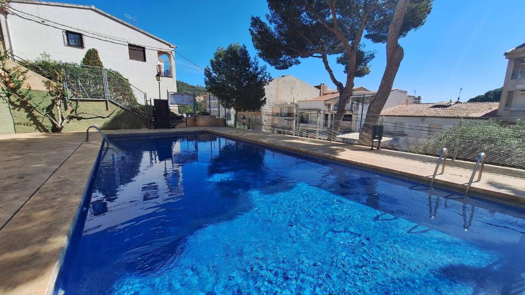 a large blue swimming pool in a yard at La Font Lovely apartment LEstartit 400 meter from the beach in L'Estartit