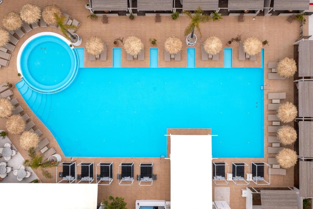 an overhead view of a swimming pool in a resort at Bamboo Suites Hotel - Adults Only in Ialysos
