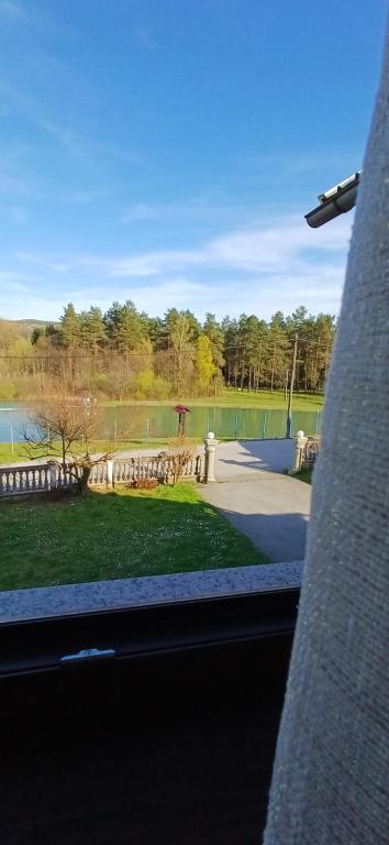 a view of a park from the window of a building at Lumaris in Ogulin