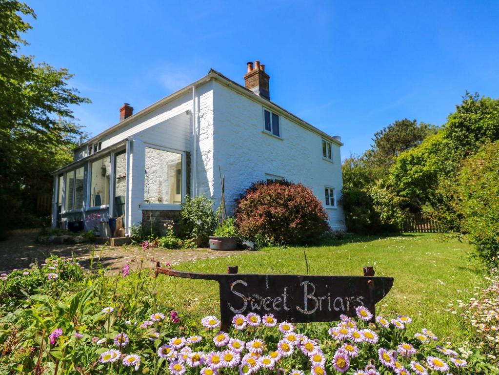 a house with a sign in the front yard at Sweet Briars in Chalegreen