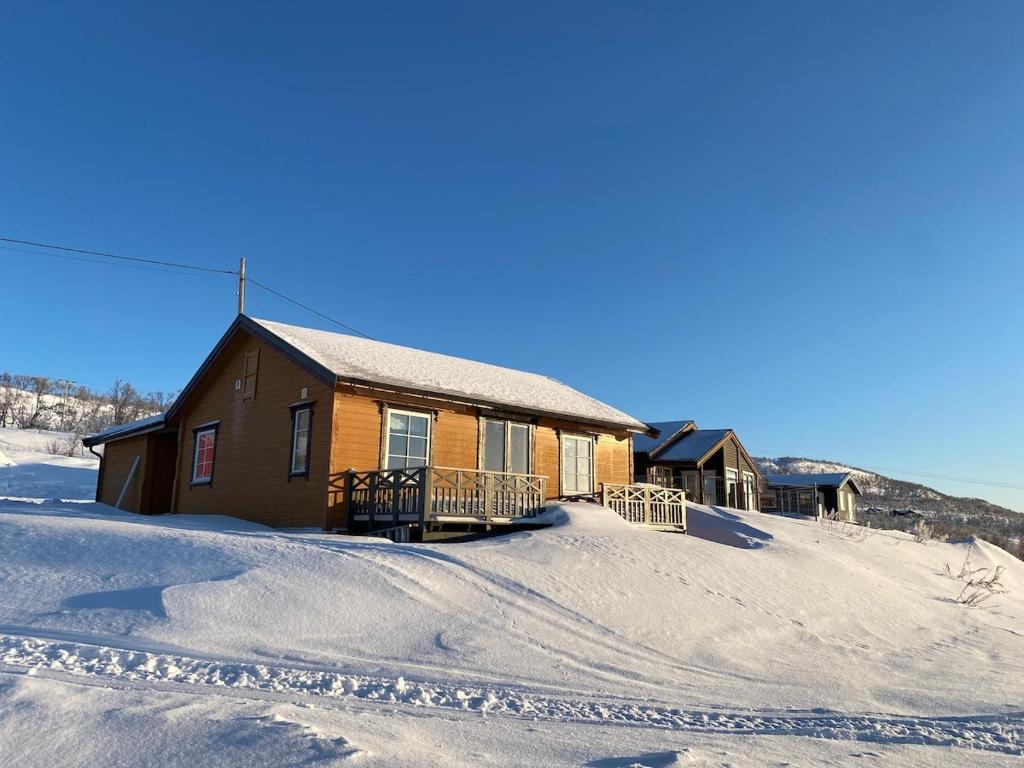 a cabin in the snow with a lot of snow at Varangerfjord Stay in Varangerbotn