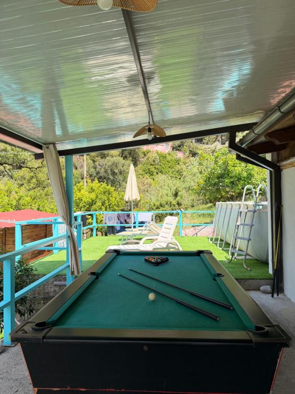 a pool table in a garage with awning at villa Cycas in Maratea
