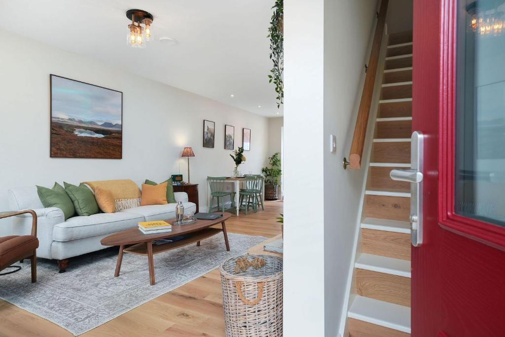 a living room with a couch and a table at Cottage 298 - Clifden in Clifden