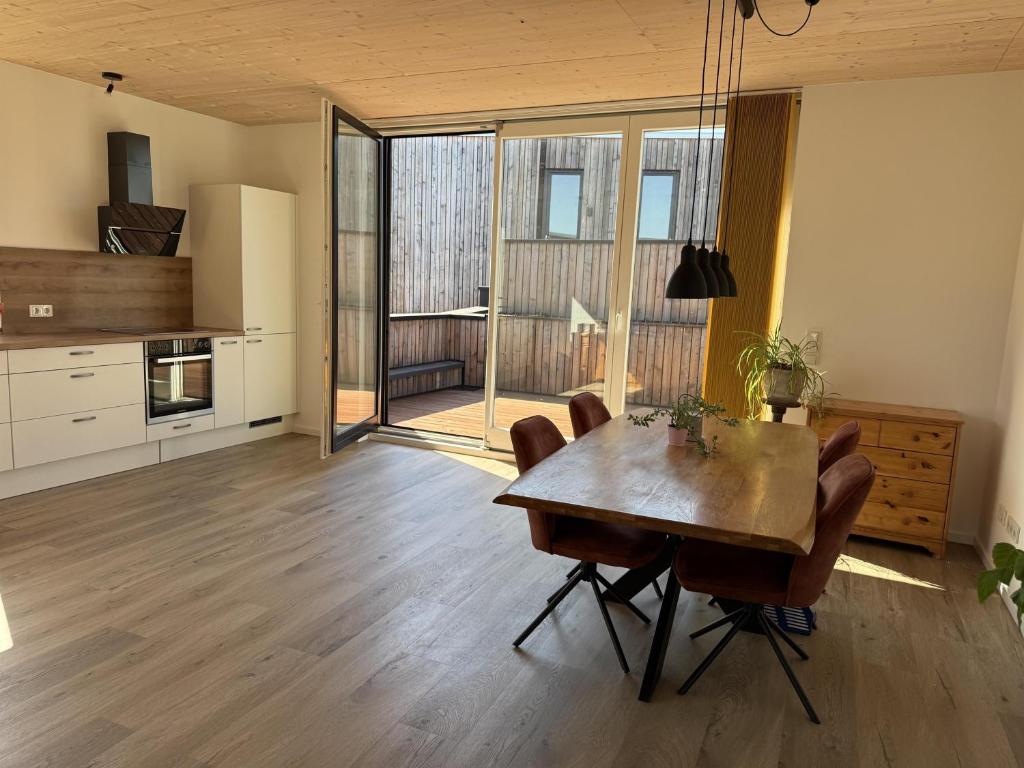 a kitchen and dining room with a wooden table and chairs at Ferienhaus Licht-Blick 9 in Wiltingen